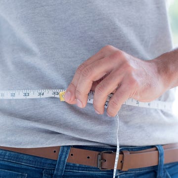 man measuring waist