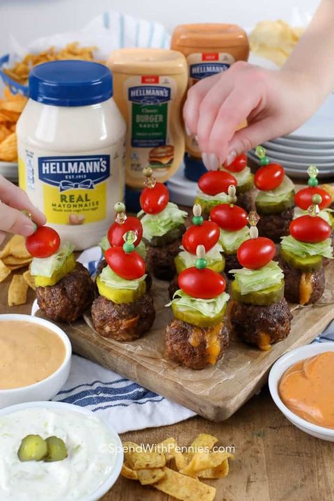 cheeseburger stuffed meatballs with cherry tomatoes and pickles on toothpicks