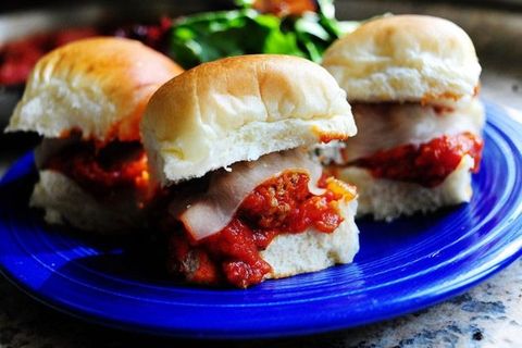 mini meatball sandwiches with tomato sauce and cheese on blue plate