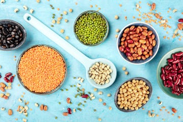 legumes, shot from the top on a blue background vibrant pulses including colorful beans, lentils, chickpeas, a flat lay composition