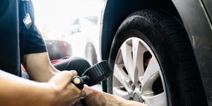 mechanic tire air pressure test in auto repair shop