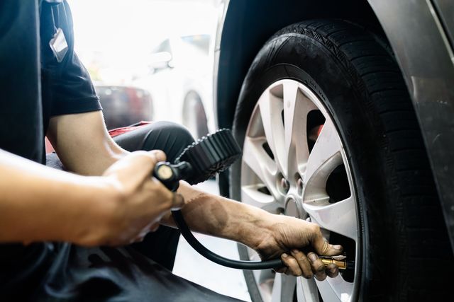 mechanic tire air pressure test in auto repair shop
