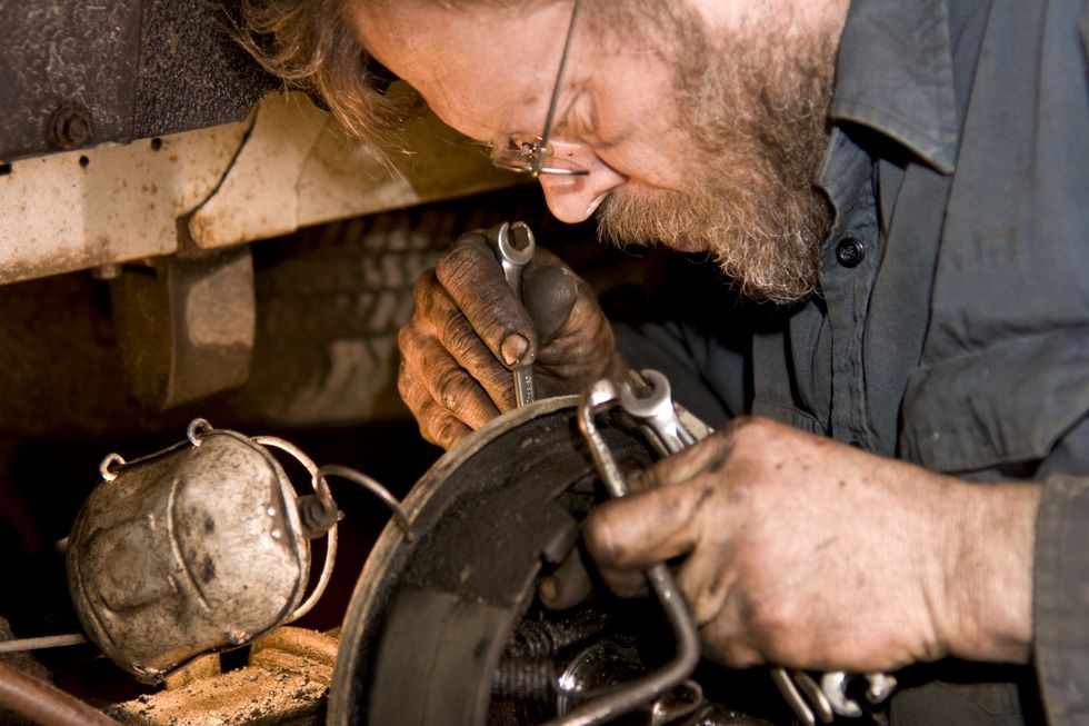 mechanic working on a car brake