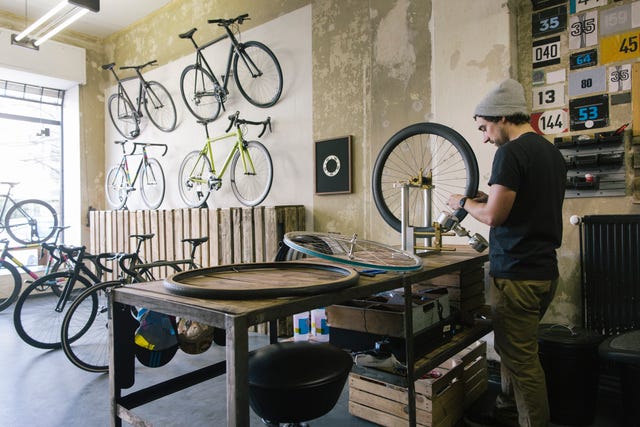 mechanic working on tire in a custom made bicycle store