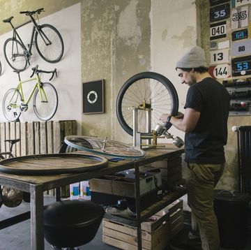 mechanic working on tire in a custom made bicycle store