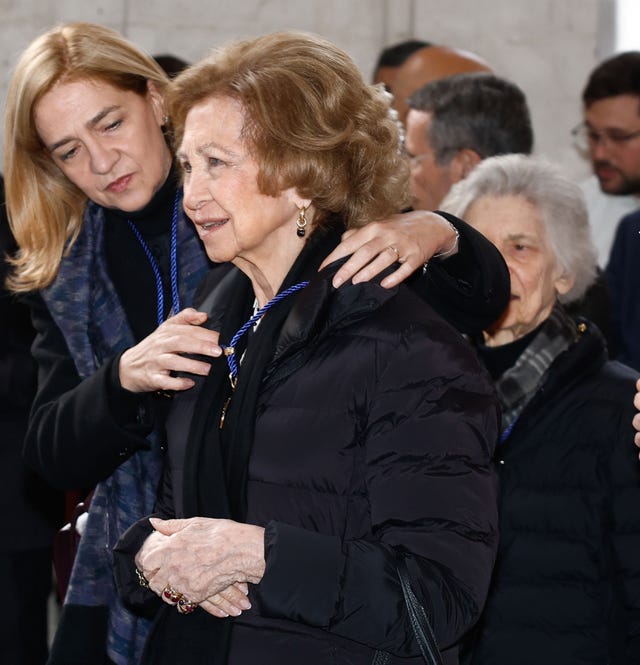 a person with the hand on another woman's shoulder