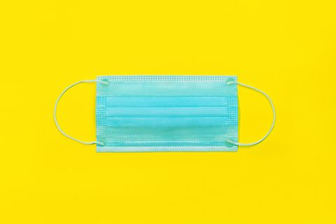 medical mask on yellow color background