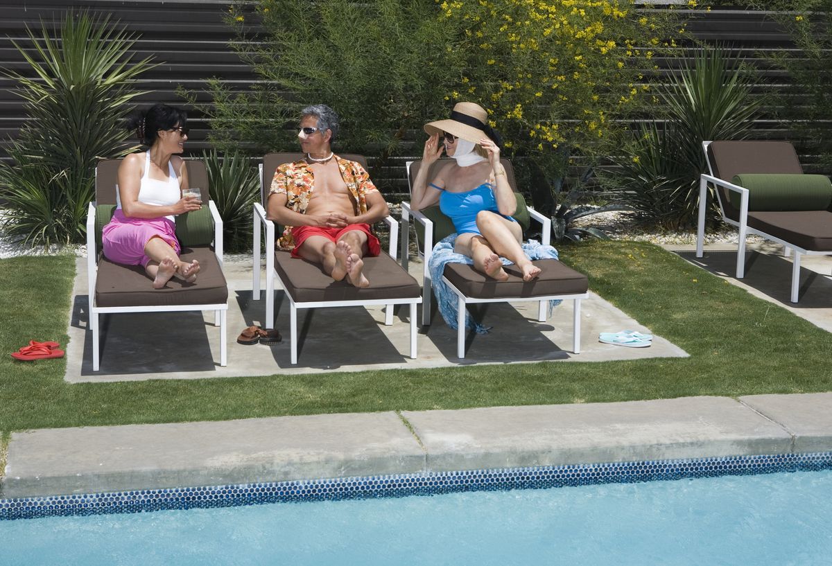 medical tourists recovering from plastic surgery by swimming pool