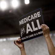 US-POLTICIS-HEALTH a member of the audience holds up a placard as us senator bernie sanders, independent from vermont, discusses medicare for all legislation on capitol hill in washington, dc, on september 13, 2017 the former us presidential hopeful introduced a plan for government sponsored universal health care, a notion long shunned in america that has newly gained traction among rising star democrats afp photo jim watson photo credit should read jim watsonafp via getty images