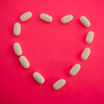 medicinal white prescription pills in shape of heart