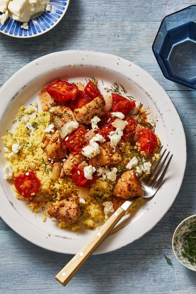 bowl with mediterranean chicken, tomatoes, feta and couscous