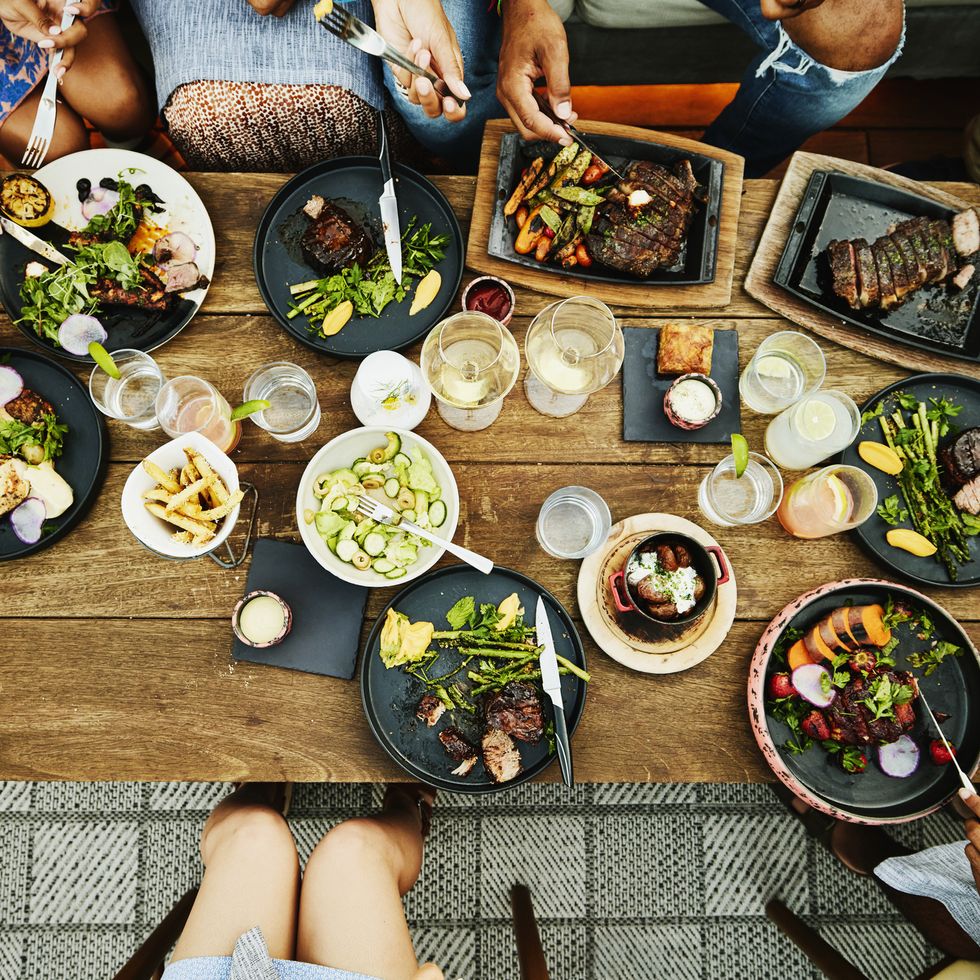 medium overhead shot of families sharing dinner at outdoor restaurant