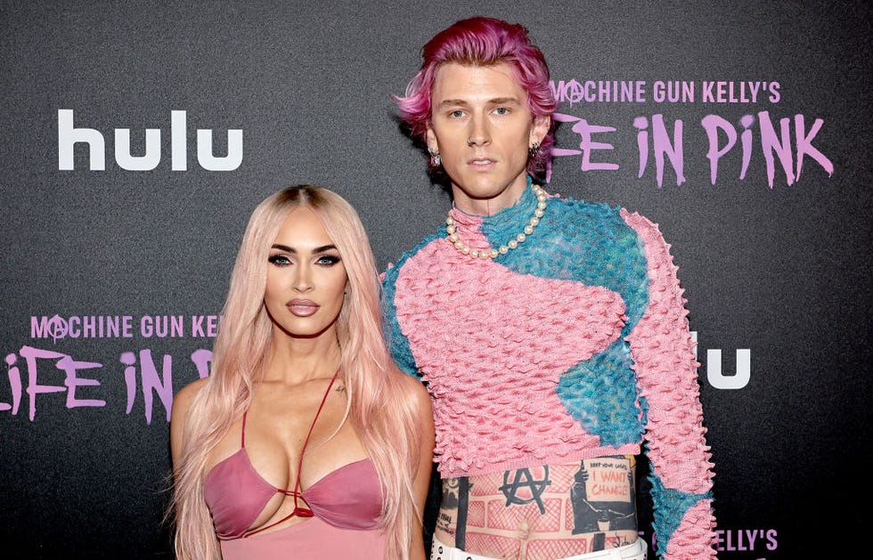 megan fox and machine gun kelly stand next to each other for photos