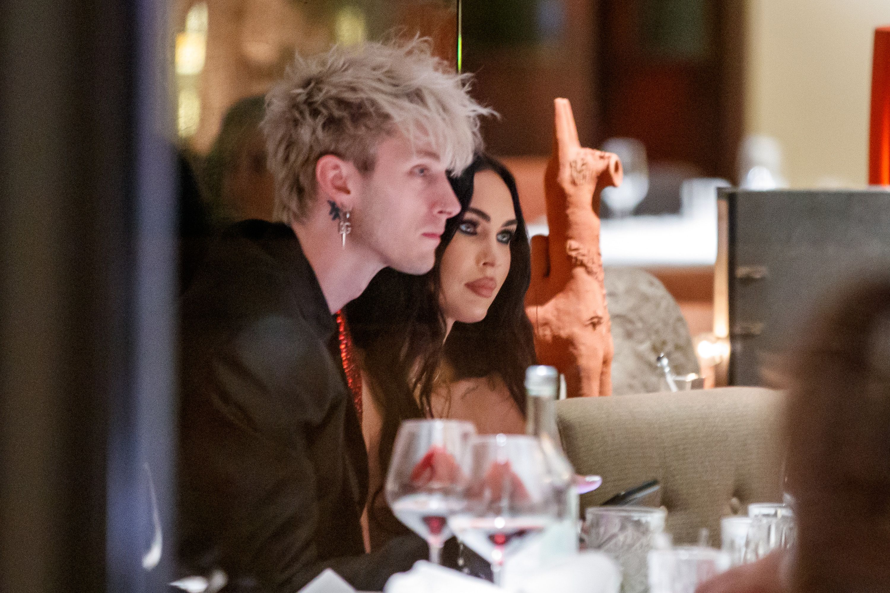 Megan Fox cheers on fiance Machine Gun Kelly as he plays during