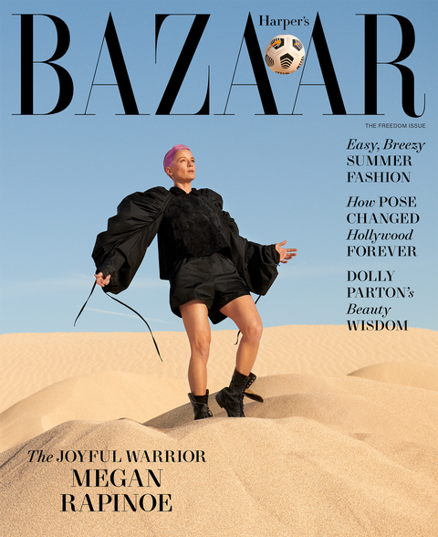magazine cover with megan in black kicking soccer ball among sand dunes