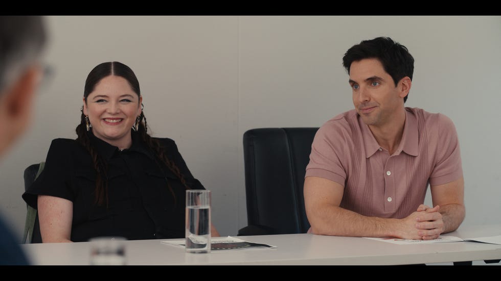 a meeting setting with two individuals seated at a table