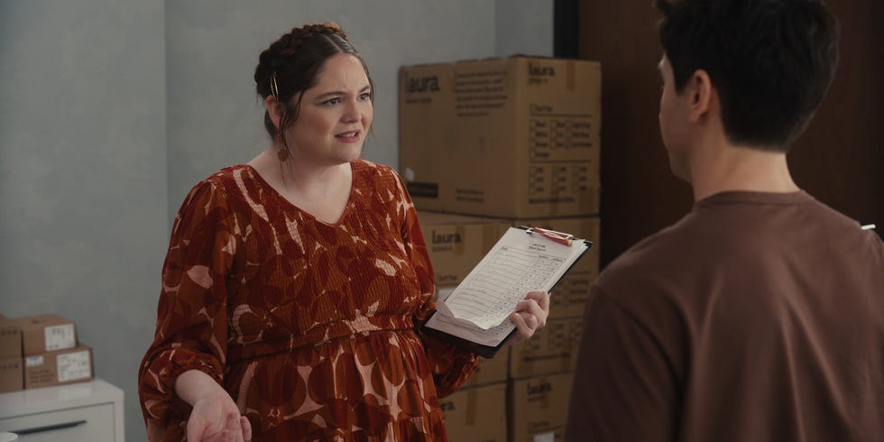 interaction between two individuals in a room with boxes