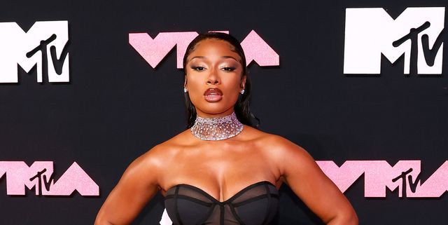 Megan Thee Stallion wears a leather bra top and matching hotpants