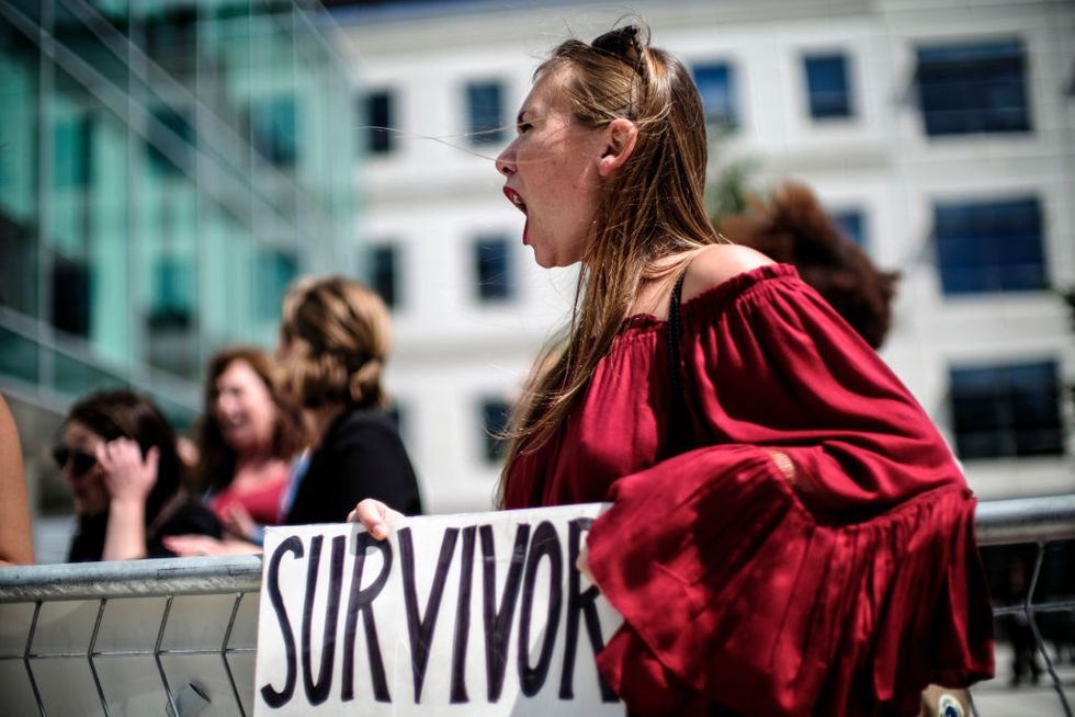 Meghan Downey of Chatham, New Jersey protests outside as U.S. Education Secretary Betsy DeVos announces changes in federal policy on rules for investigating sexual assault reports on college campuses in Arlington, Virginia...