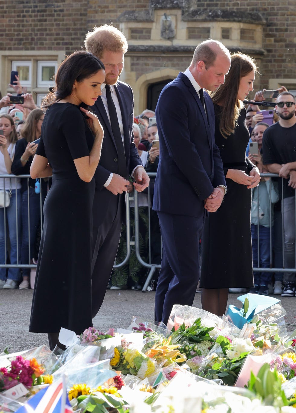 the prince and princess of wales accompanied by the duke and duchess of sussex greet wellwishers outside windsor castle
