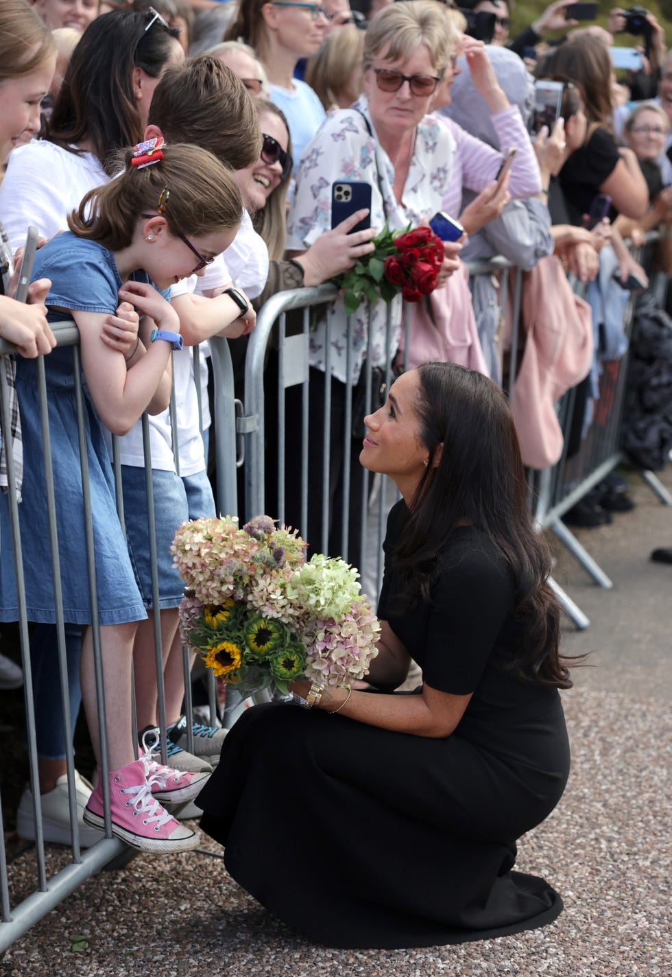 the prince and princess of wales accompanied by the duke and duchess of sussex greet wellwishers outside windsor castle
