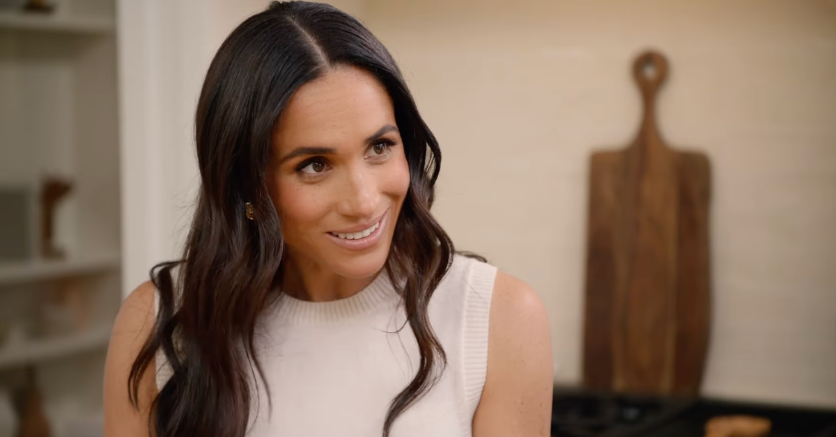 meghan markle engaged in cooking in a kitchen environment