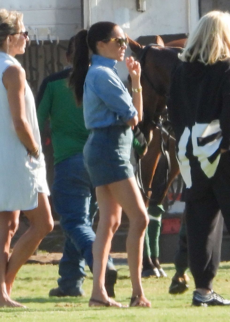 meghan markle in a denim outfit watching prince harry play polo on may 15, 2022