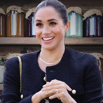 a person smiling with a gold chain