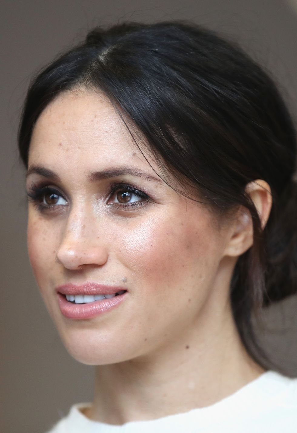 a photo of meghan markle with a glowing complexion,  one of good housekeeping's royal beauty hacks
