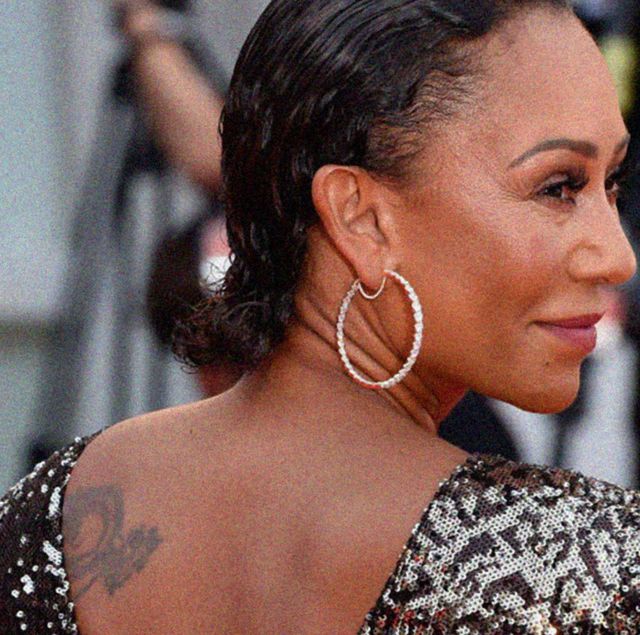 mel b pictured smiling as she turns away from the camera wearing a sequin dress on a red carpet