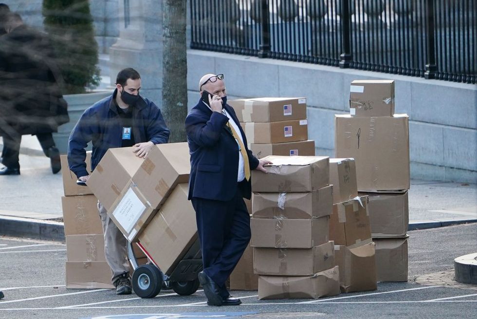 a worker stacks boxes on west executive avenue before loading them onto a truck at the white house in washington, dc on january 14, 2021 photo by mandel ngan  afp photo by mandel nganafp via getty images