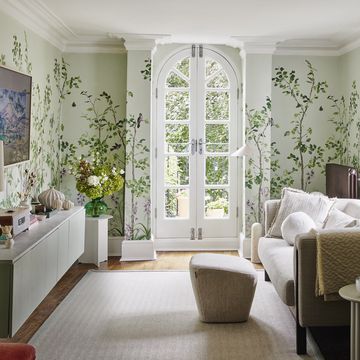 living room in melanie lissacks home with a white french door and botanical wallpaper