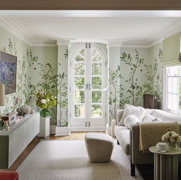 living room in melanie lissacks home with a white french door and botanical wallpaper