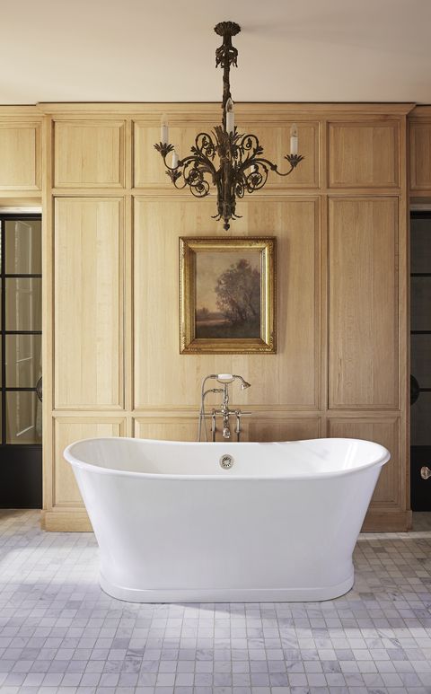 handsome oak paneling and a deep soaking tub headline the owners bath