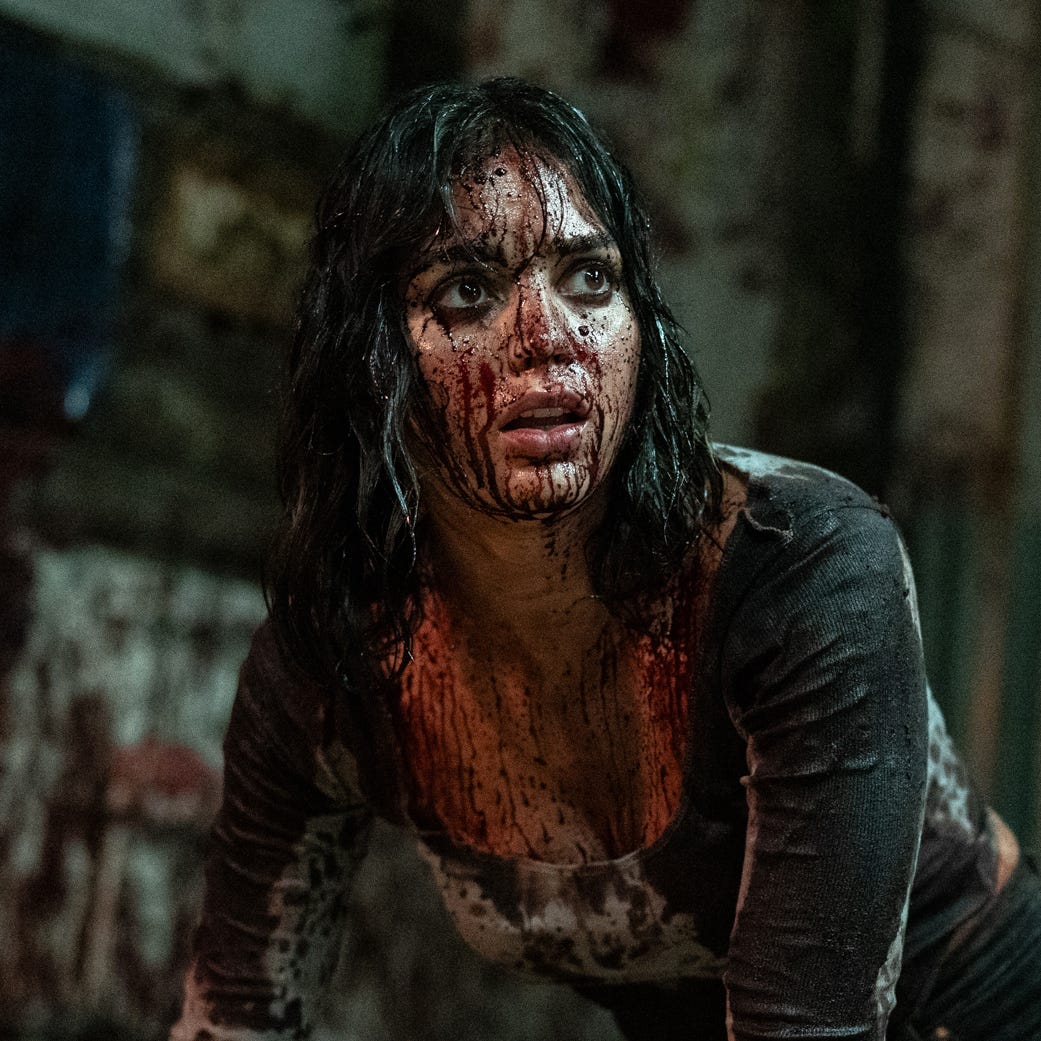 melissa barrera as joey covered in blood in abigail movie