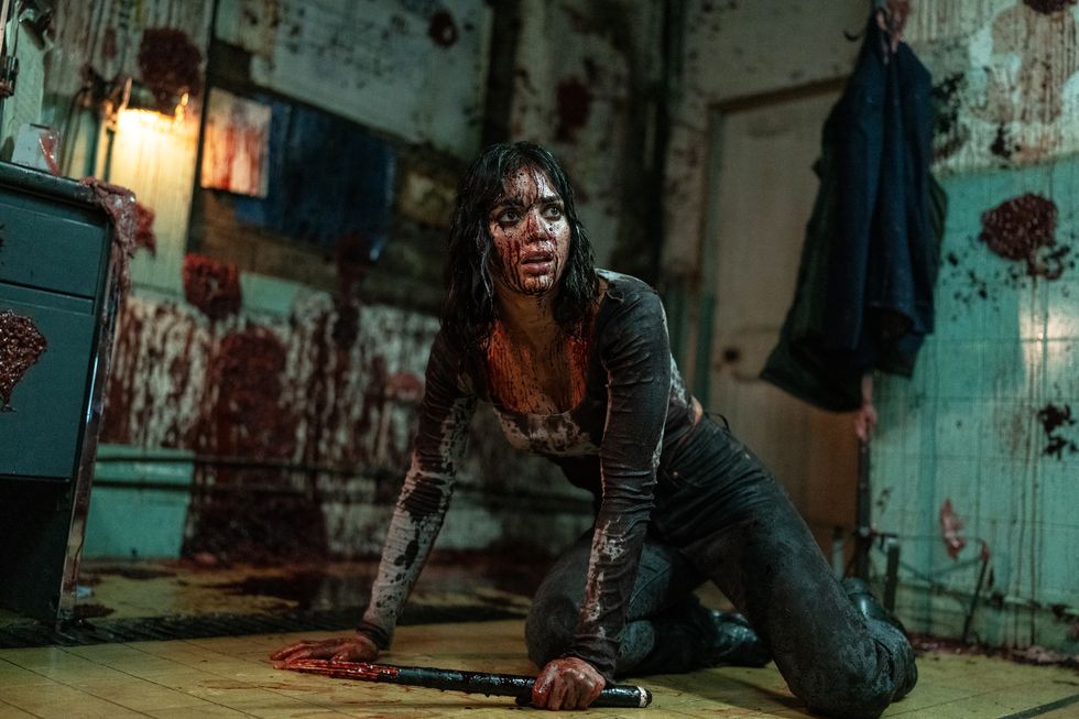 melissa barrera as joey covered in blood in abigail movie