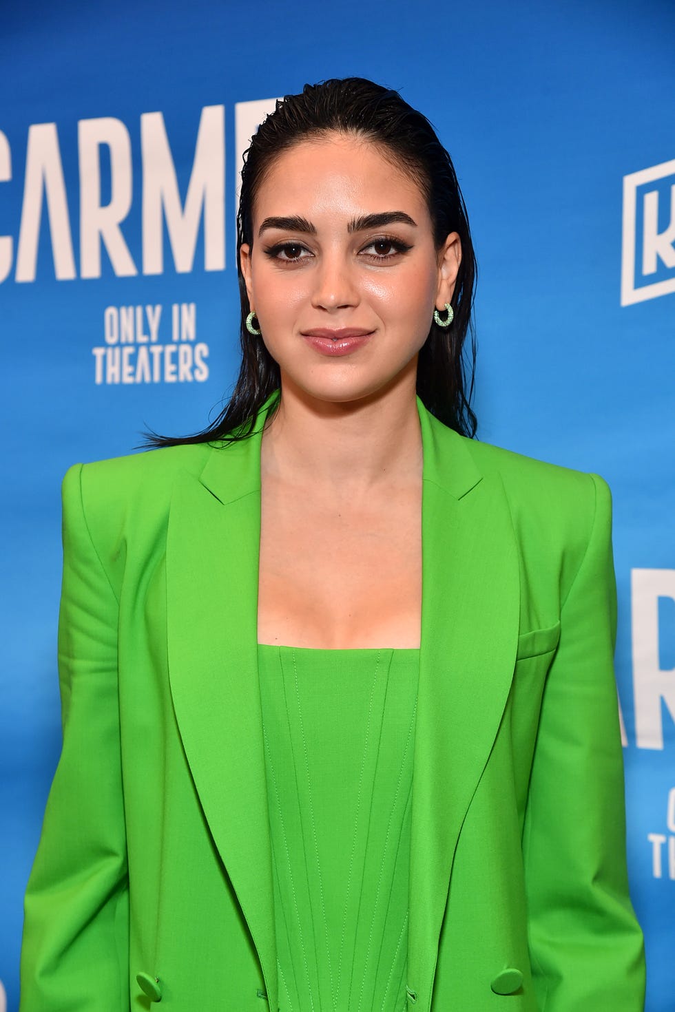 melissa barrera in a green suit