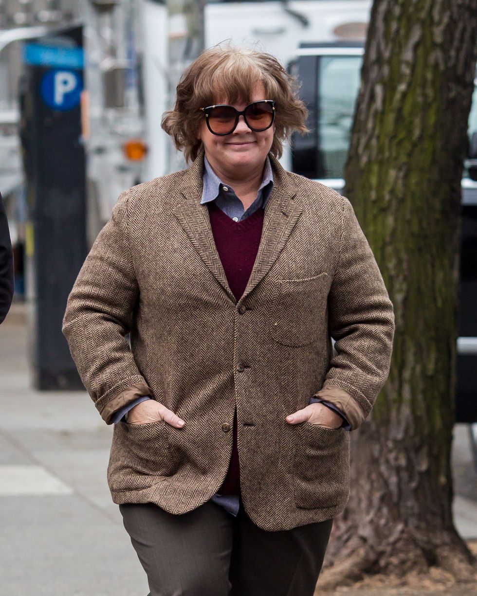melissa mccarthy walking along a sidewalk in costume
