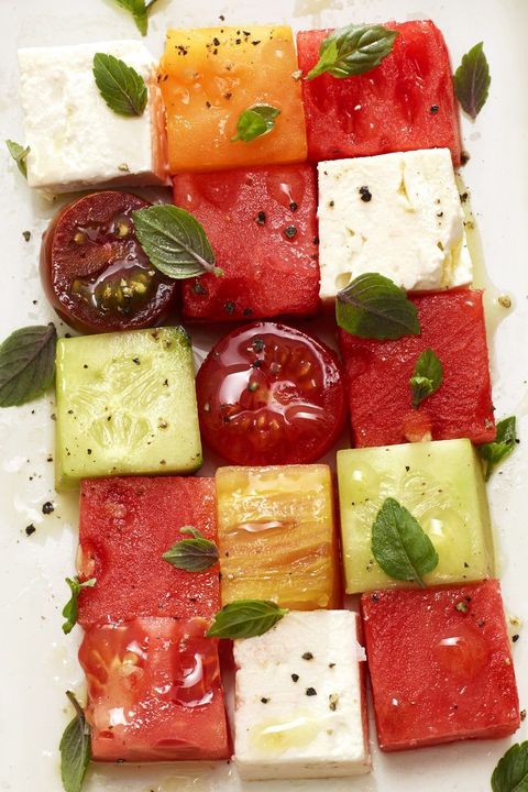 squares of melons with tomatoes and olive oil drizzled on top