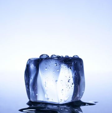 melting ice cube and reflection, close up