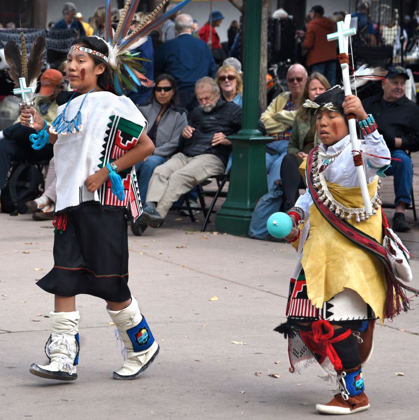 members of a dance troupe in new mexico participate in an indigenous peoples' day celebration