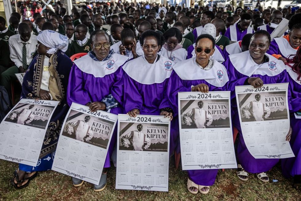 members of the eldoret cathedral choir hold commemorative calendars while attending kelvin kiptum's funeral