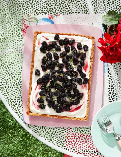 blackberry coconut tart on a platter outdoors