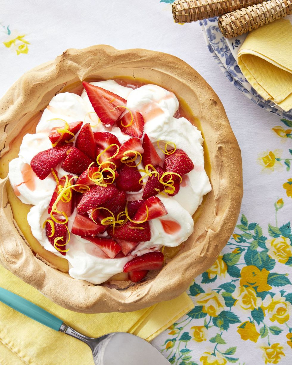 memorial day desserts strawberry lemonade angel pie with whipped cream and sliced strawberries and lemon zest on top