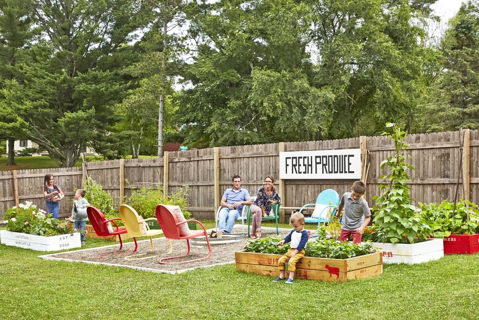 family in a backyard garden with firepit