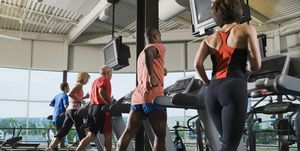 men and women running on treadmills