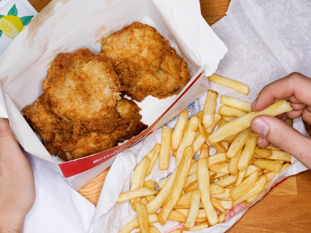 man eating fast food, fries chicken and fries