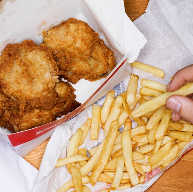 Man eating fast food, fries chicken and fries man eating fast food, fries chicken and fries