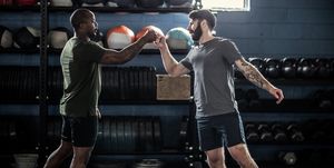 men fist bumping after cross training class