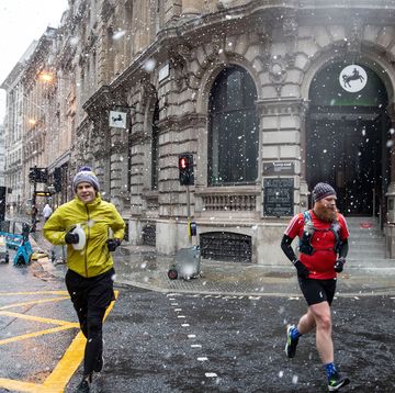 men jogging during snow fall across the capital